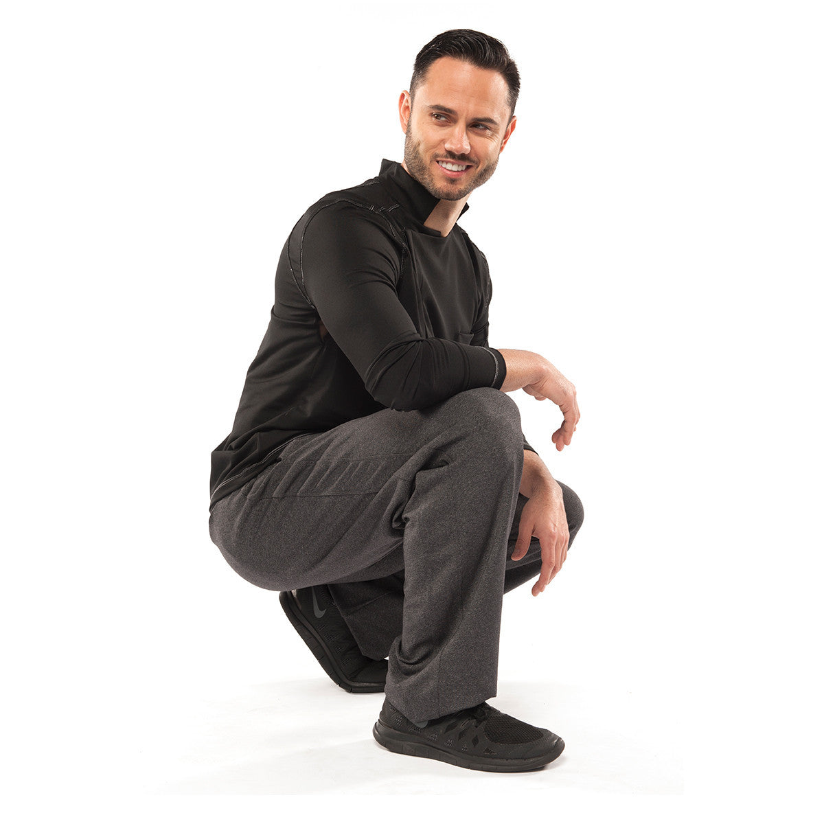 model wearing coat in black and pants in carbon color